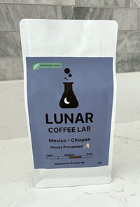 Lunar Coffee Lab Mexico Chiapas honey-processed coffee in a white pouch with a periwinkle label and the moon-and-flask mark.