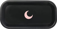 Matte black tray with softly rounded corners and a blush moon at its centre, seen from above.