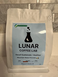 Lunar Coffee Lab Decaf Guatemala HueHue, 8oz, in a white pouch with a pale blue label and the moon-and-flask mark.