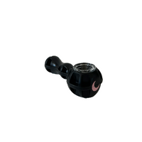 Black textured silicone spoon piece with a removable glass bowl and blush moon mark, on white.