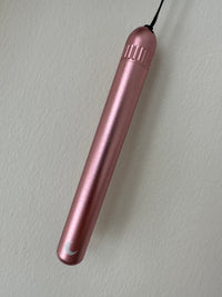 Rose-pink anodised metal tube with a ribbed screw cap, keychain cord and white moon mark.