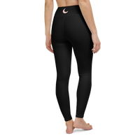 Black high-waist leggings worn back-to-camera, with a blush crescent moon at the waistband.