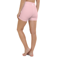 Blush pink high-waist yoga shorts worn back-to-camera, with a white crescent moon at the waistband.