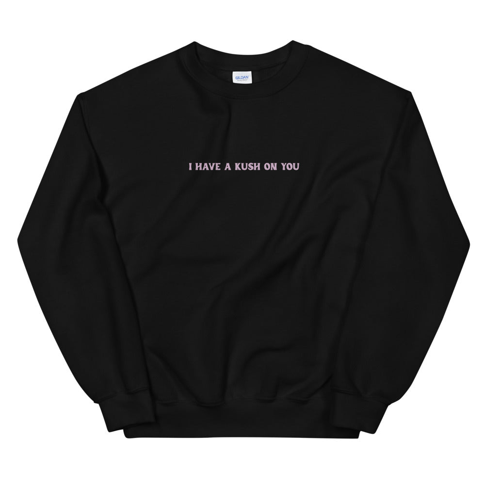 Black crewneck sweatshirt with a small blush slogan printed across the chest.