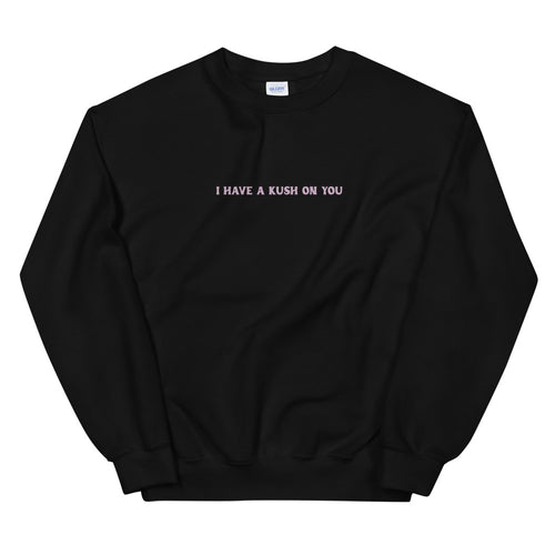 Black crewneck sweatshirt with a small blush slogan printed across the chest.
