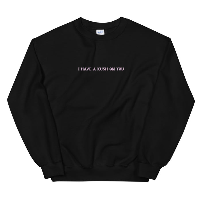 Black crewneck sweatshirt with a small blush slogan printed across the chest.