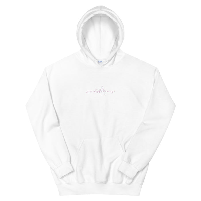 White pullover hoodie with a fine blush script slogan across the chest.