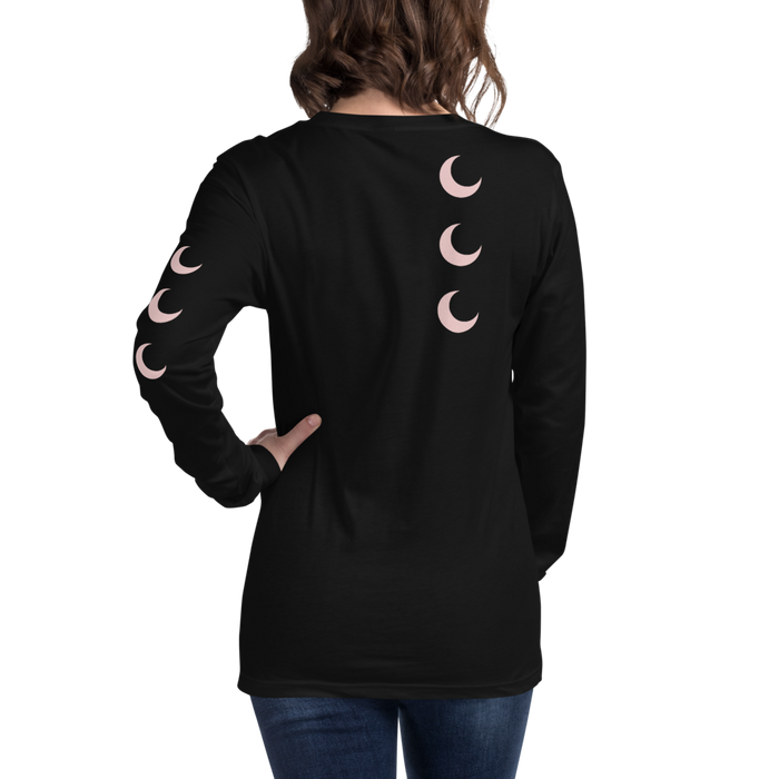 Black long sleeve tee worn back-to-camera, with blush crescent moons falling down the spine and one sleeve.